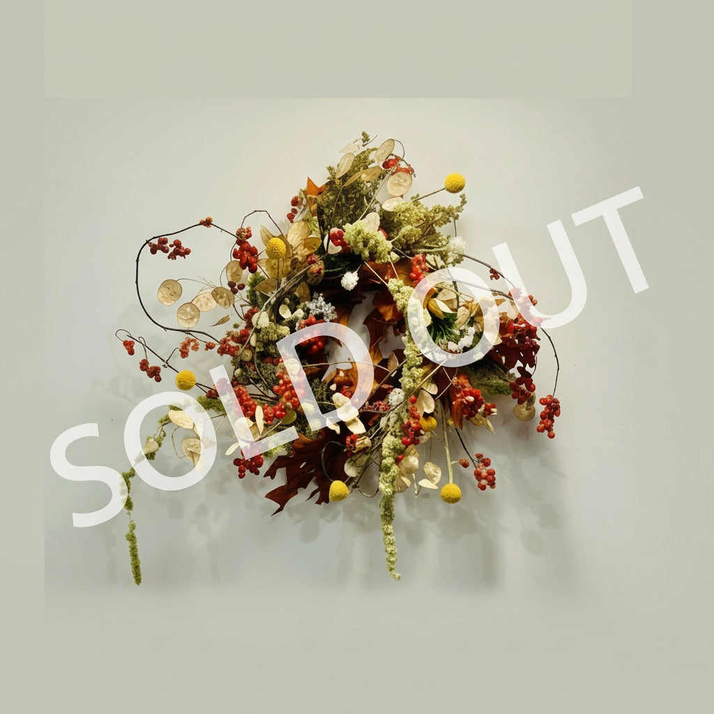 Decorative wreath with autumnal elements on a light gray background