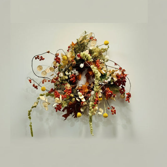 Decorative wreath with autumnal elements on a light gray background