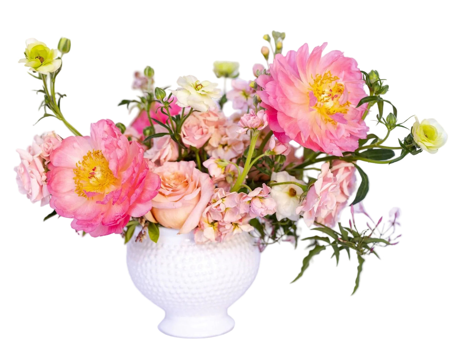 Bouquet of pink, peach, and white flowers in a white vase on a light background